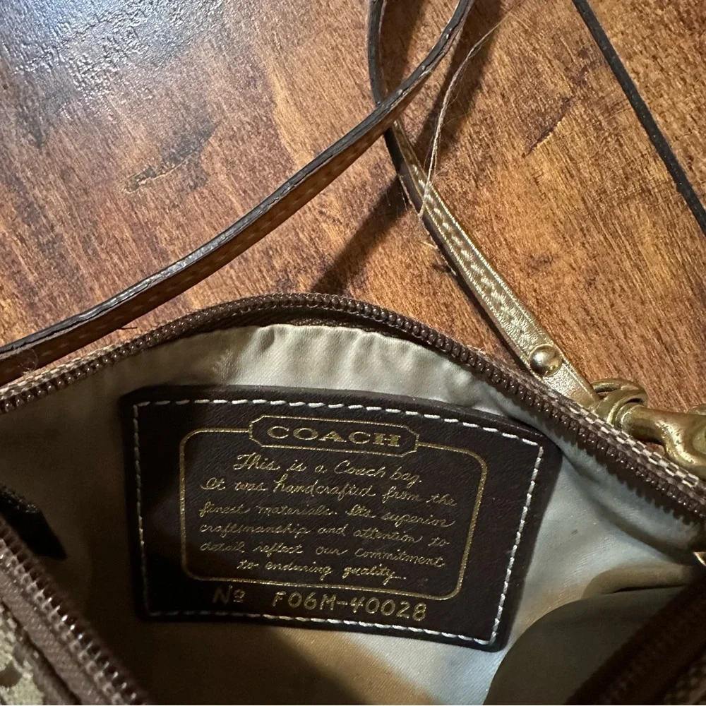 Coach brown and gold sateen horizontal stripe monogram wristlet